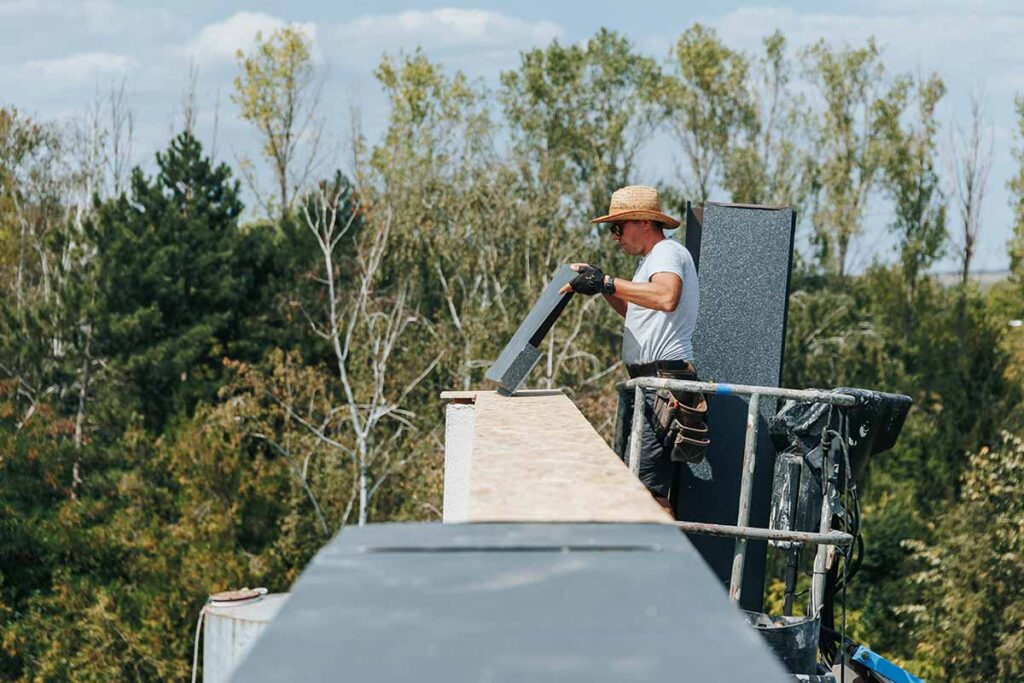 Professional technician performing chimney cleaning services outdoors