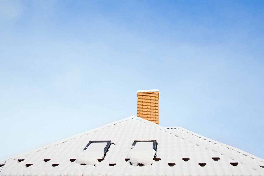 Snow-covered roof with chimney - Chimney Cleaning Services Near Me